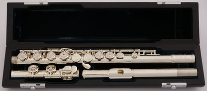 Azumi AZ1 flute displayed in an open case with a green velvet interior, revealing the silver body, headjoint and closed hole keywork 