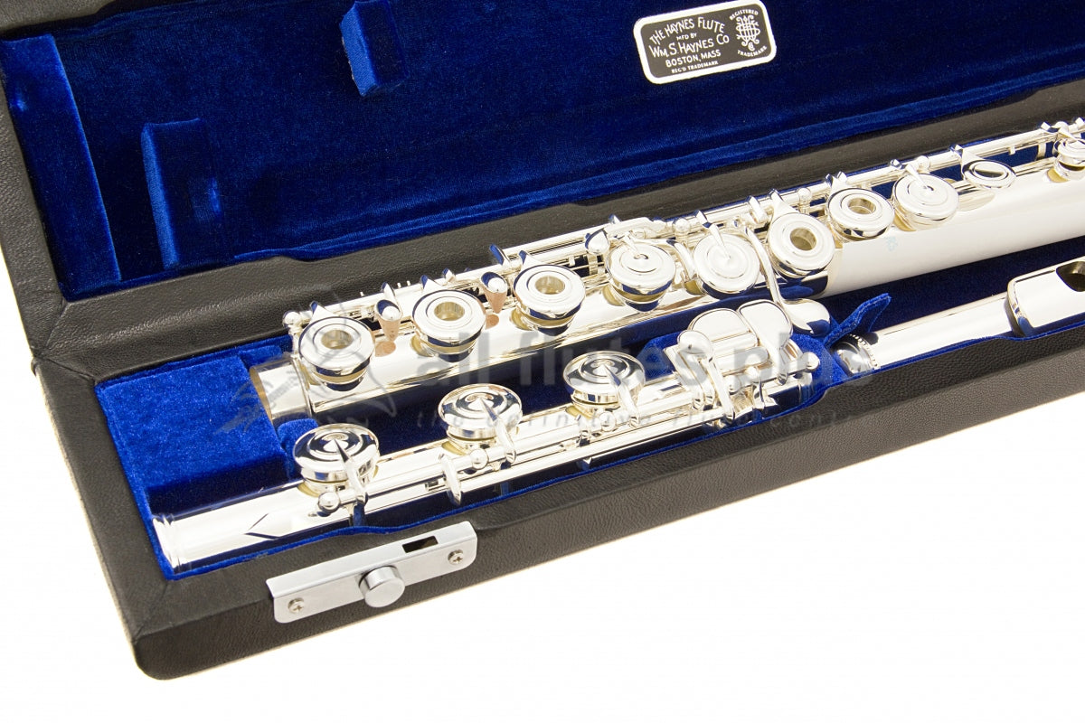 Haynes Q2RE Flute displayed in its open case with blue interior, close up of the B footjoint and body joint open hole keywork of the flute