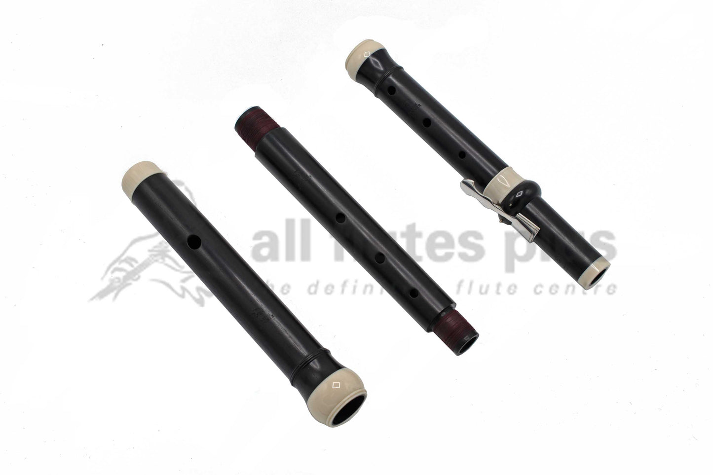 Wooden baroque flute in three parts laid out next to one another