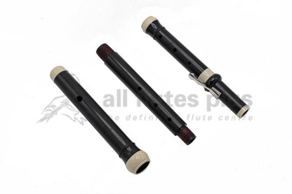 Wooden baroque flute in three parts laid out next to one another