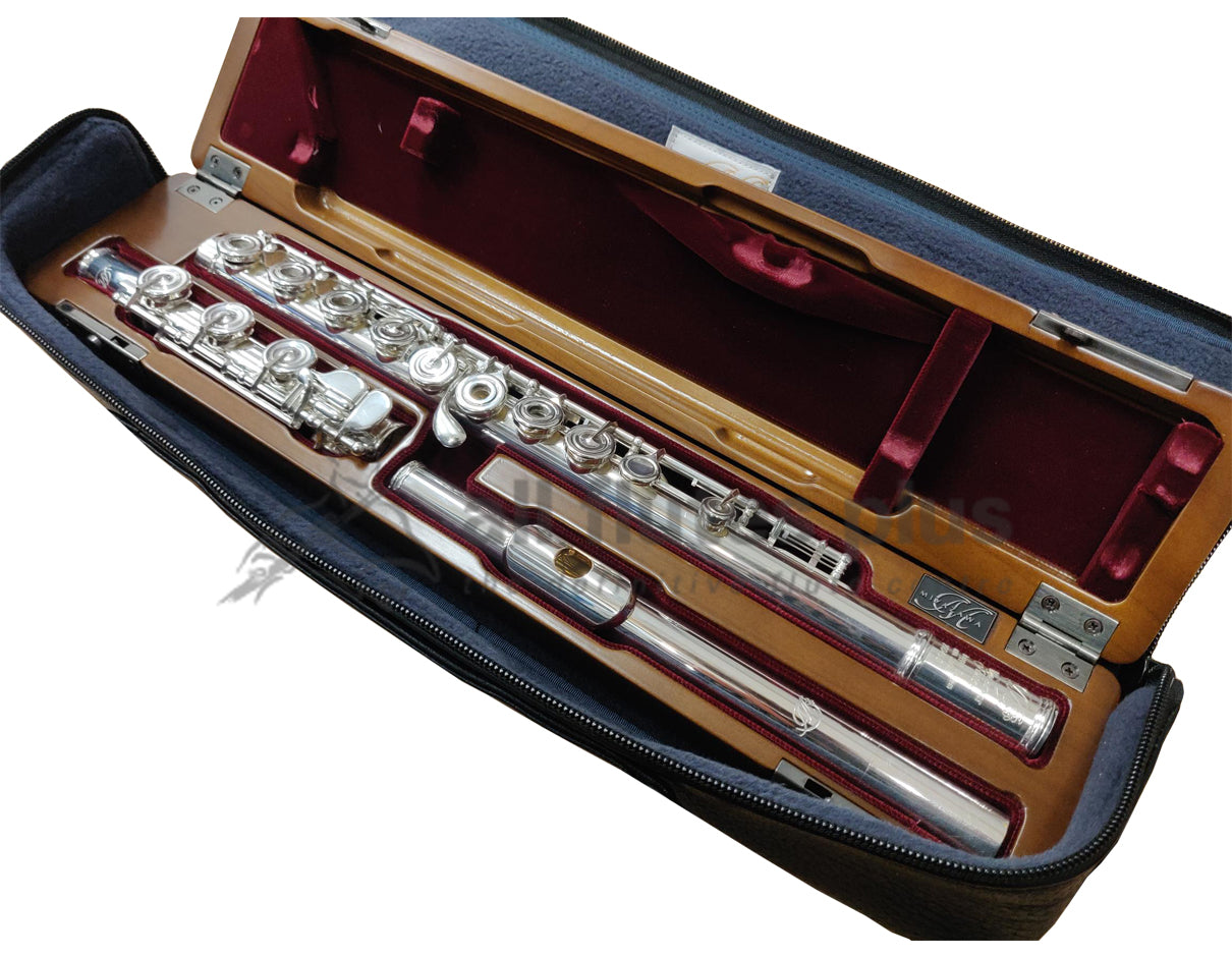 Miyazawa CS - A Flute lying in cherrywood hardcase with red velvet lining places in an open black case cover.