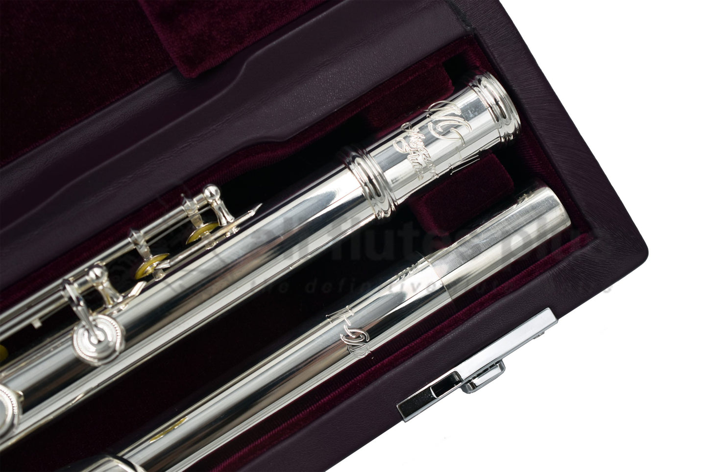 The Miyazawa MJ 25 logo on body tube of flute whilst lying in a burgundy velvet lined hard case.