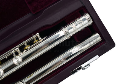 The Miyazawa MJ 25 logo on body tube of flute whilst lying in a burgundy velvet lined hard case.