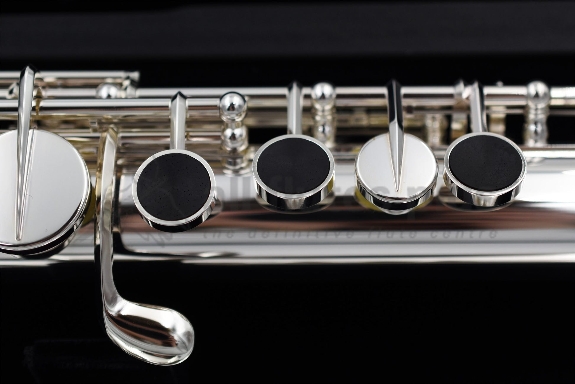 Close up of Miyazawa ST Alto flute left hand mechanism specifically the grenadilla wood touch pieces