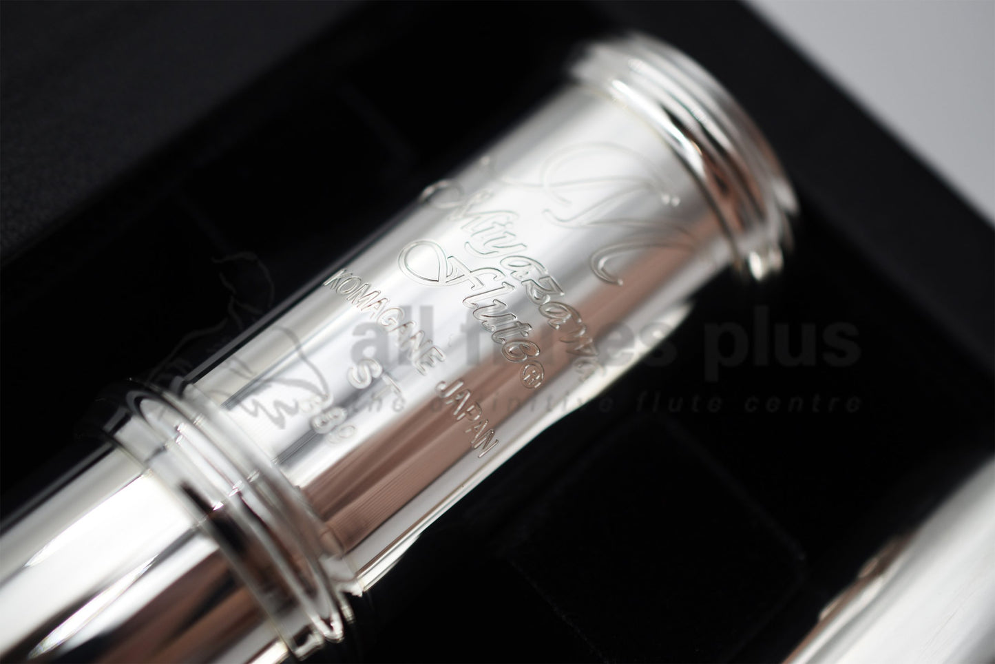 Close-up of a Miyazawa ST Alto Flute with silver body and Grenadilla wood finger buttons.