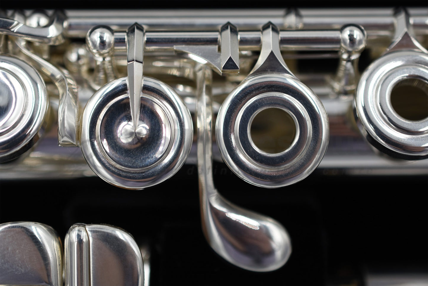 Close up of the G key and E mechanism of a silver Nagahara flute set in the flute case