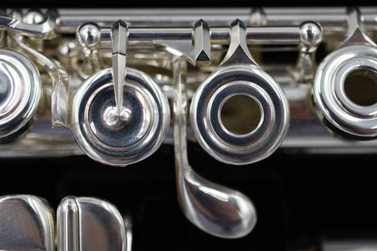 Close up of the G key and E mechanism of a silver Nagahara flute set in the flute case