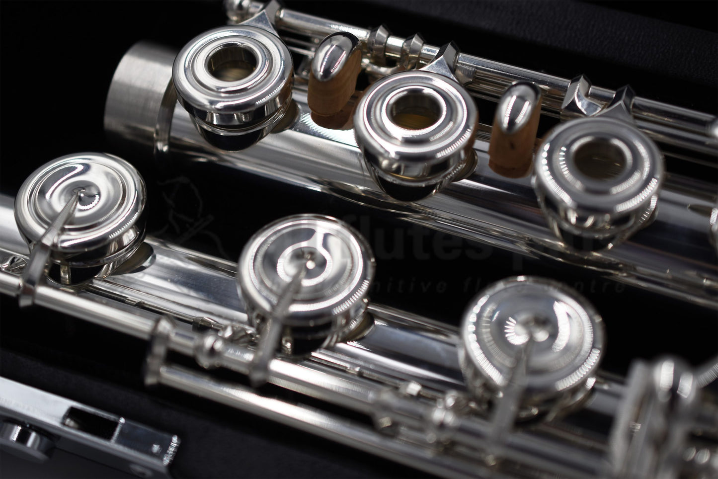 Close up of footjoint and right hand body tube mechanism of Nagahara flute set in the flute case