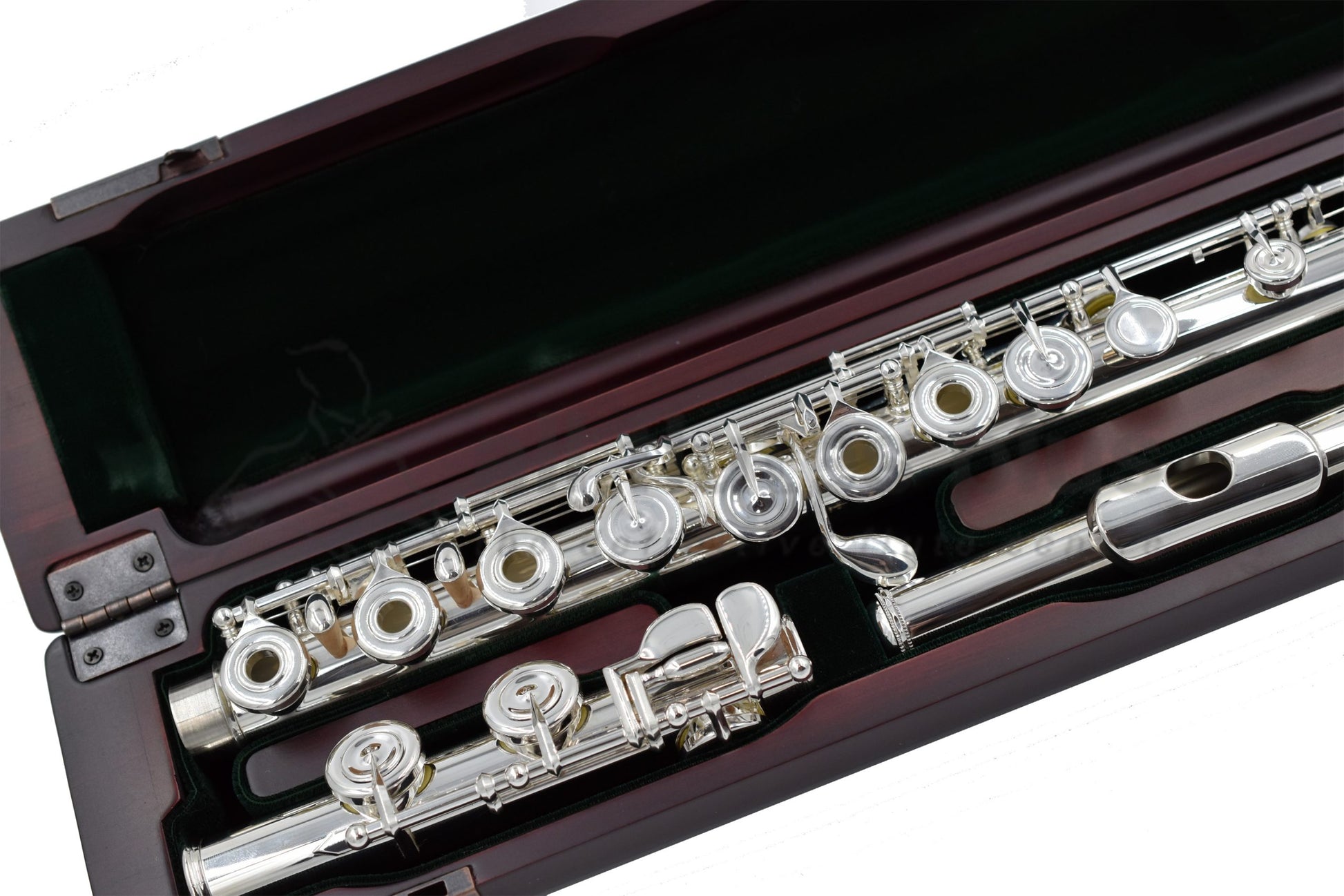 Close up of Pearl PF 695RE Flute set in a cherrywood open case showing body tube and foojoint mechanism