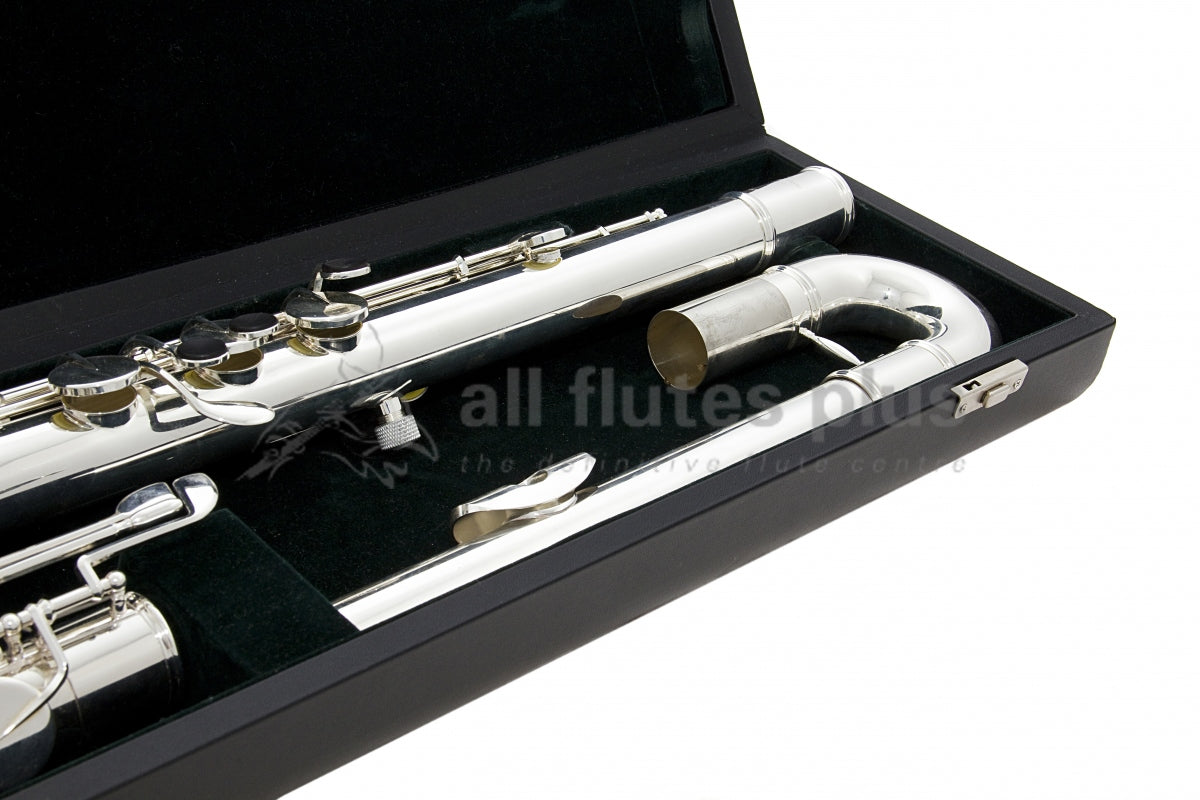 Pearl bass flute close up of curved headjoint and left hand of the body tube, set inside the black flute case
