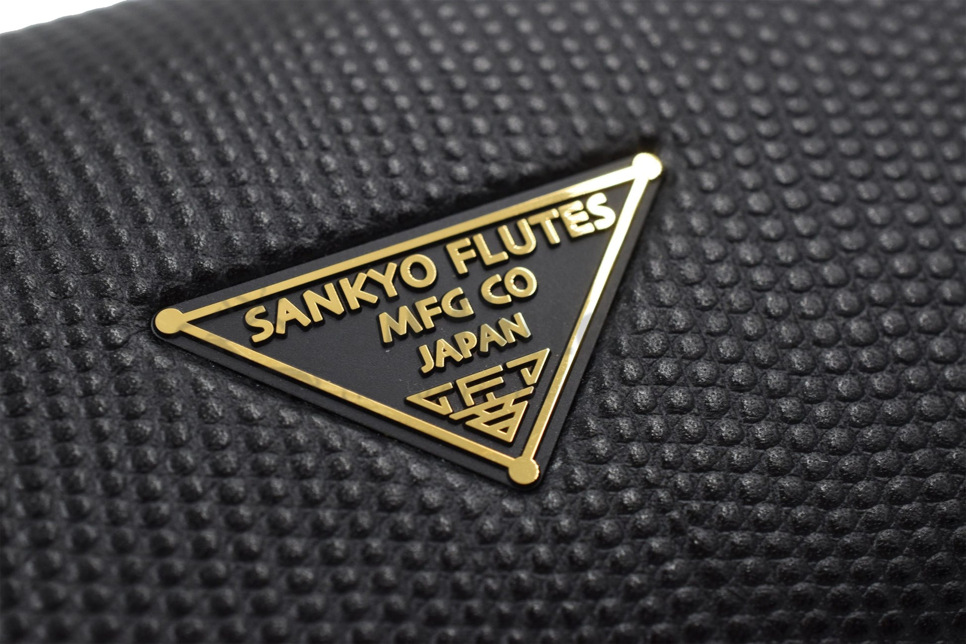 Close up of triangular Sankyo flute logo on hard case 