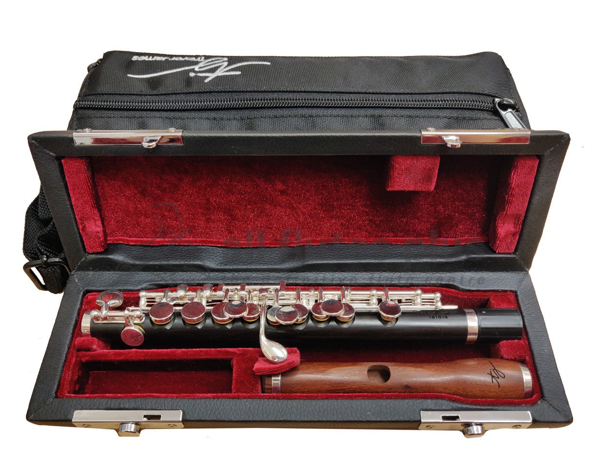 Trevor James Grenadilla model piccolo with Rosewood headjoint displayed in its open flute case with red velvet interior