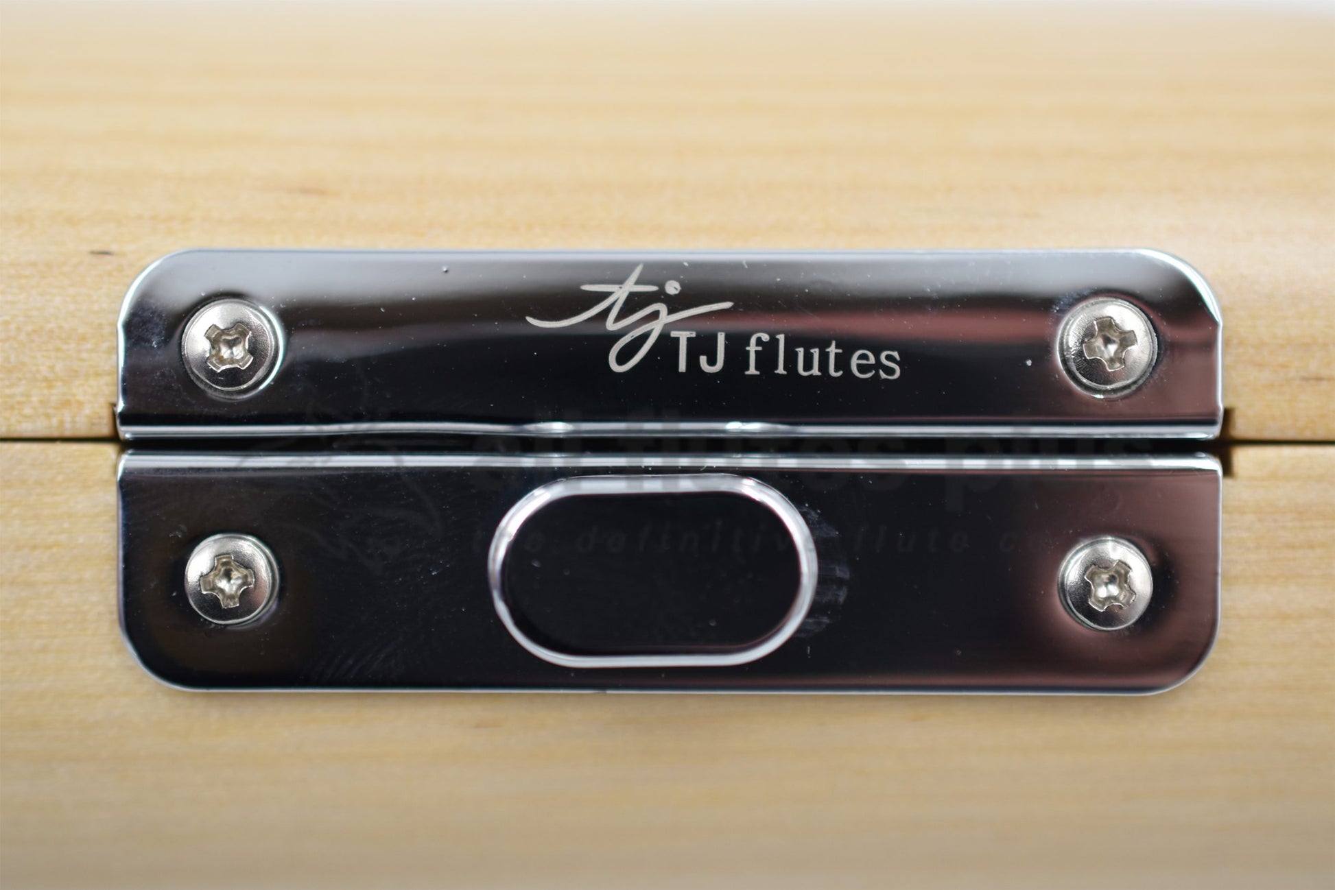 Close up of TJ Flutes logo on piccolo hard case latch