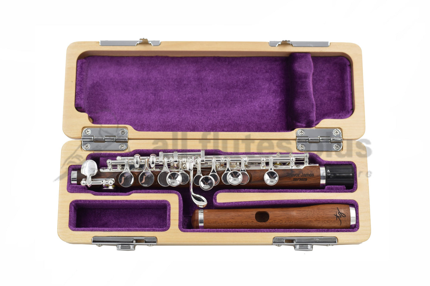 Trevor James Mopane Wood Piccolo displayed in an open case with a purple interior, showing the wood body, silver-plated mechanism, and a Mopane wood headjoint.
