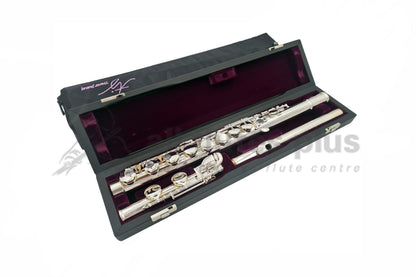 Trevor James Alto flute displayed in its open flute case with purple velvet interior, straight headjoint and soft case cover behind